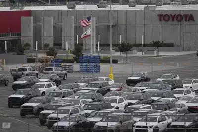 New Toyota vehicles are stored at an imports processing facility in Long Beach, California. (AP Photo/Damian Dovarganes) India caught in crossfire as Trump's 25% auto tariffs roil global supply chains