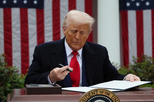 U.S. President Donald Trump signs an executive order on tariffs, in the Rose Garden at the White House in Washington, D.C., U.S., April 2, 2025. REUTERS