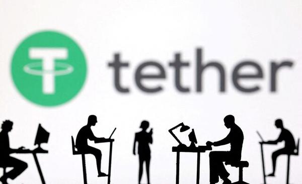 Figurines with computers and smartphones are seen in front of Tether logo in this illustration taken, Feb. 19, 2024. REUTERS