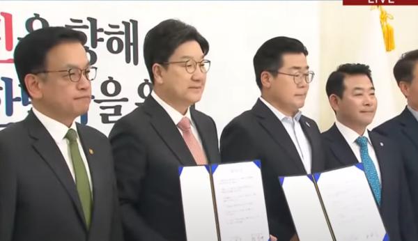 Kwon Sung-dong and Park Chan-dae, alongside Deputy Prime Minister Choi Sang-mok, celebrate the agreement on the supplementary budget bill.