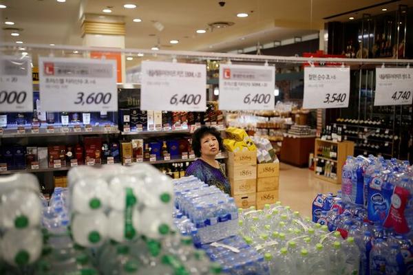 A woman shops at a market in Seoul. REUTERS