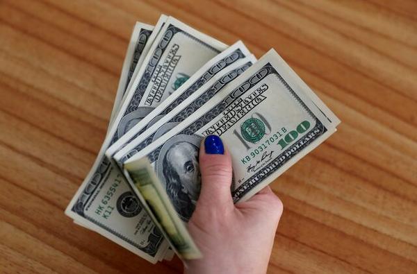 A woman shows U.S. dollar bills at her home in Buenos Aires, Argentina Aug. 28, 2018. REUTERS