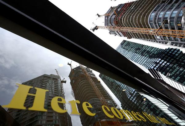 The construction site of '4 Frankfurt' skyscraper reflected in a shop window in Frankfurt, Germany