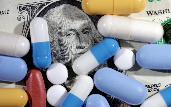 U.S. dollar banknote and medicines are seen in this illustration taken, June 27, 2024. REUTERS
