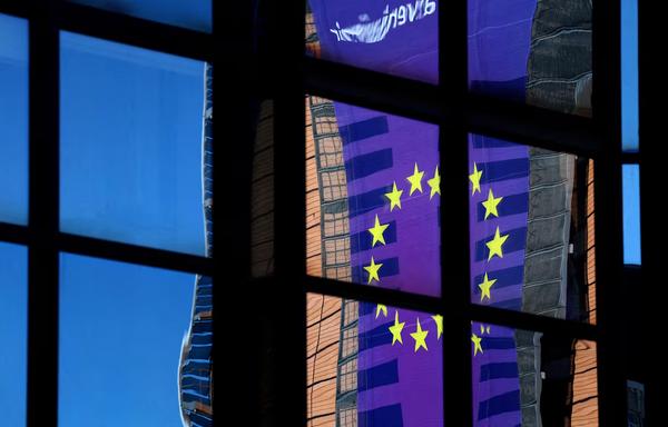 A banner depicting an European Union flag is reflected in a window outside the EU Council headquarters in Brussels, Belgium March 18, 2025. REUTERS