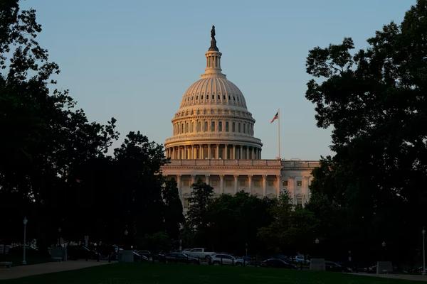 U.S. Capitol building at sunrise during the reading of the spending and tax bill
