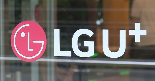 The logo of LG Uplus on a glass door