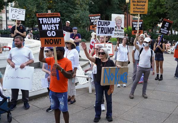 Demonstrators protest at Dupont Circle following Trump's announcement to deploy the National Guard and federalize D.C.'s police.